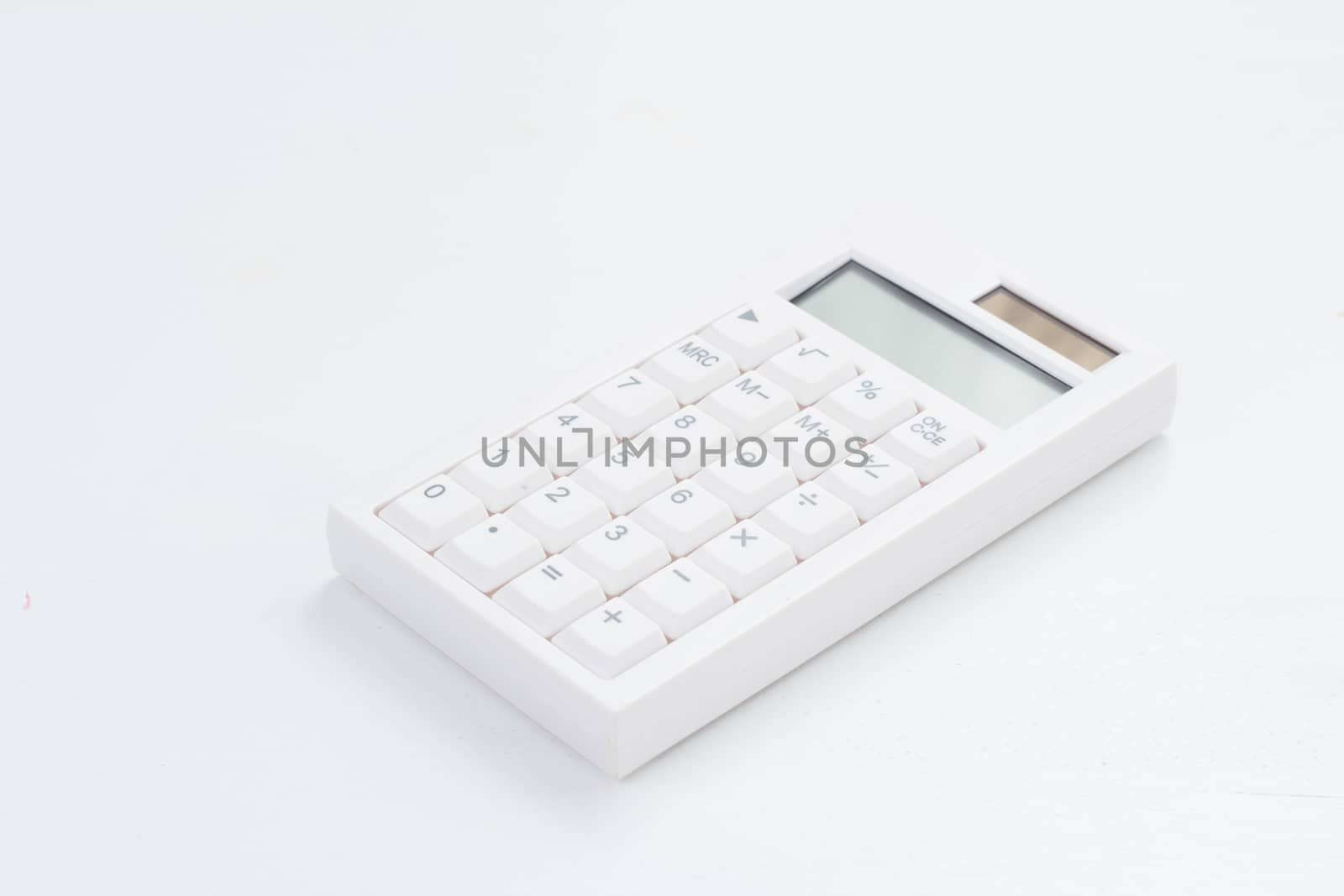 White calculator on the white table