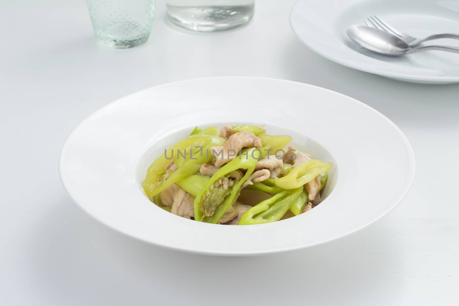 pork fried with sweet pepper. Thai food on white dish