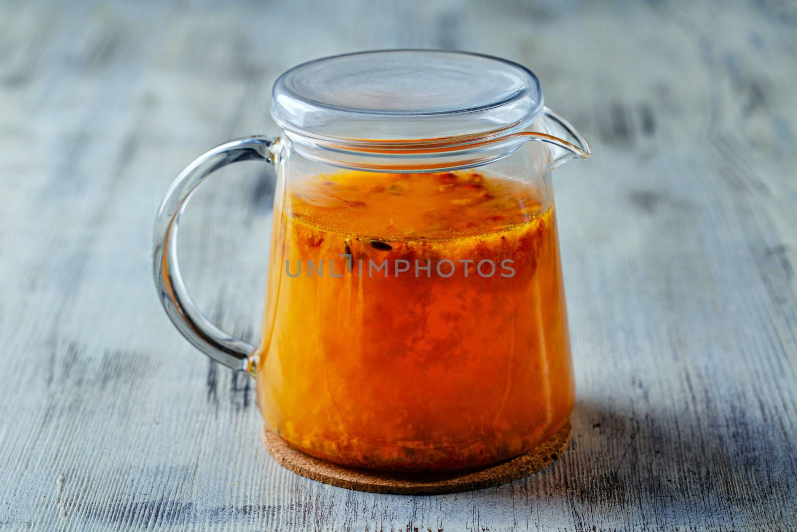 Glass tea kettle on the wooden table closeup shot