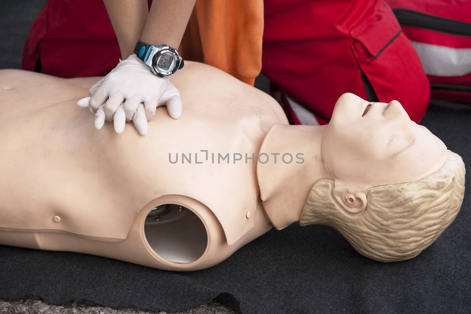 Paramedic demonstrates CPR on dummy