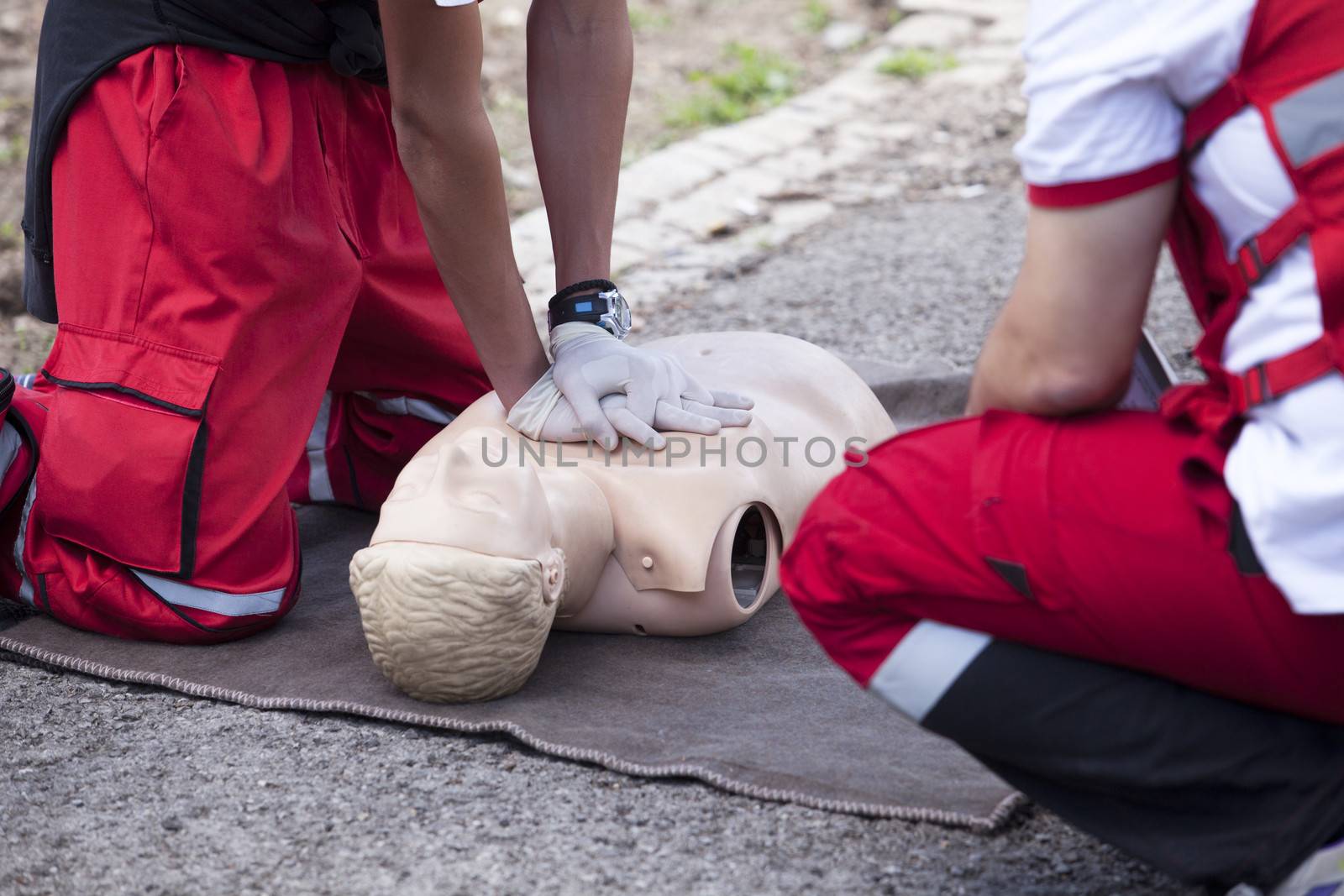 Paramedic demonstrates CPR on dummy