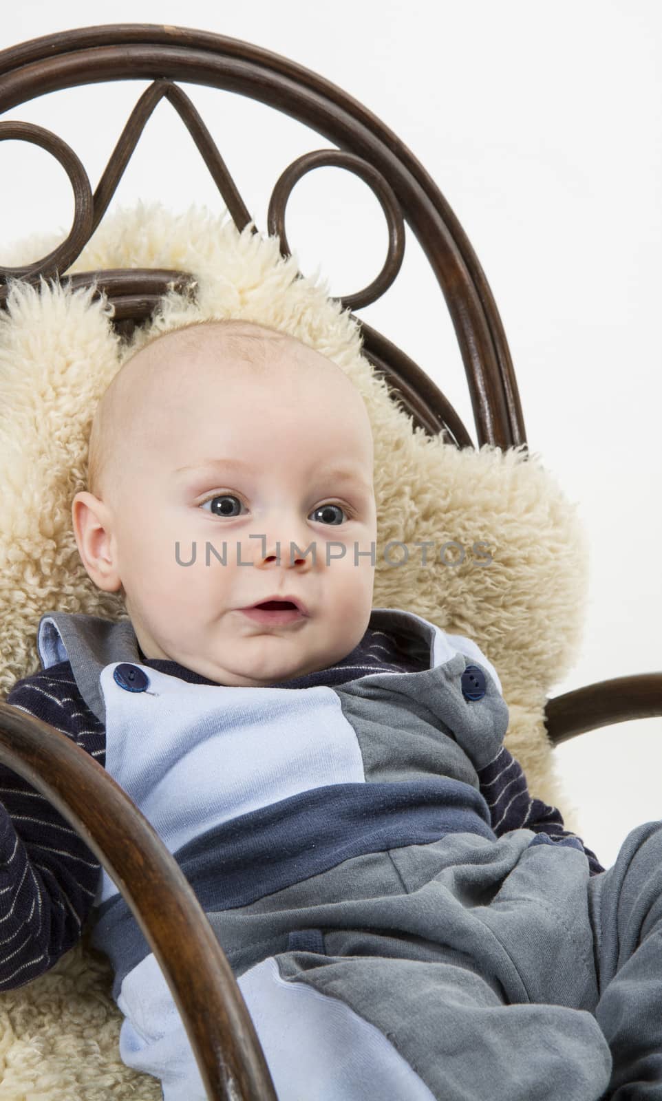 newborn child in rocking chair. studio shot