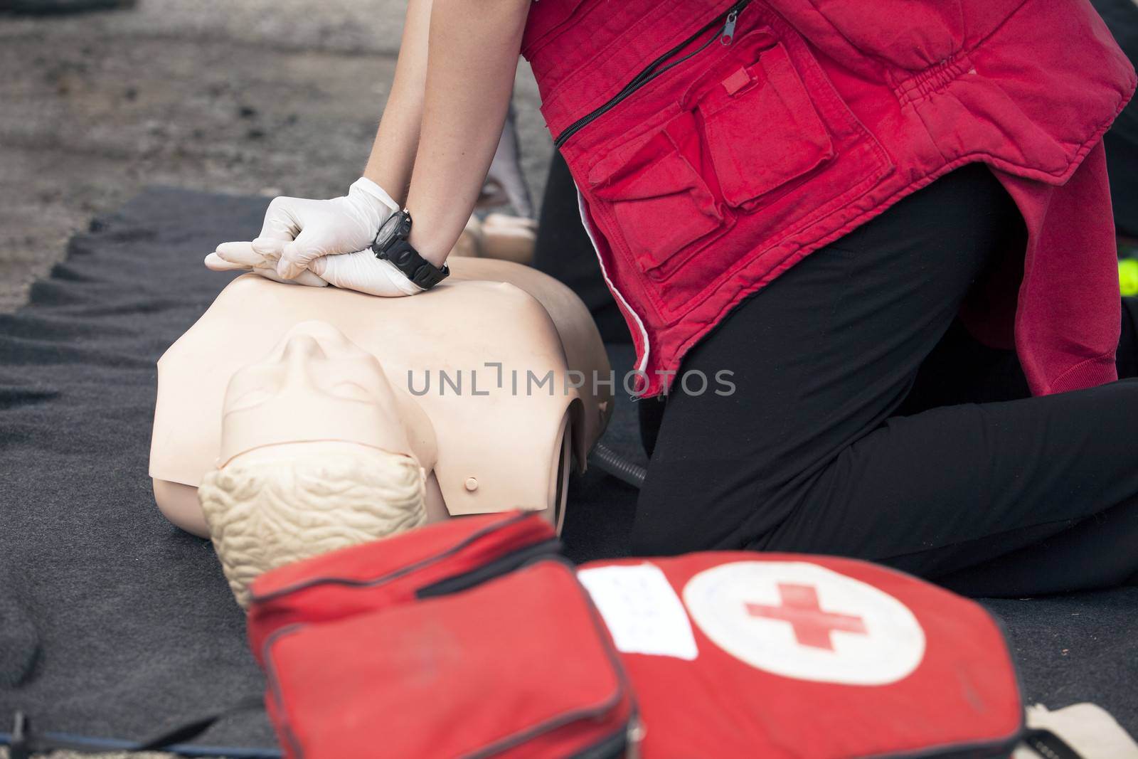 Paramedic demonstrates CPR on dummy