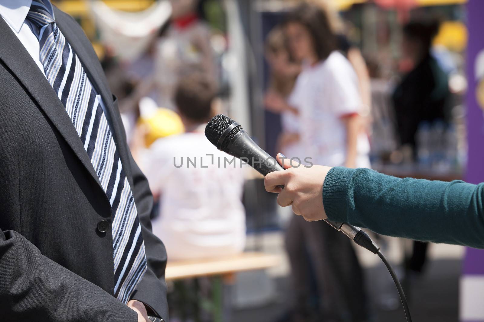 A journalist is making a interview with a microphone