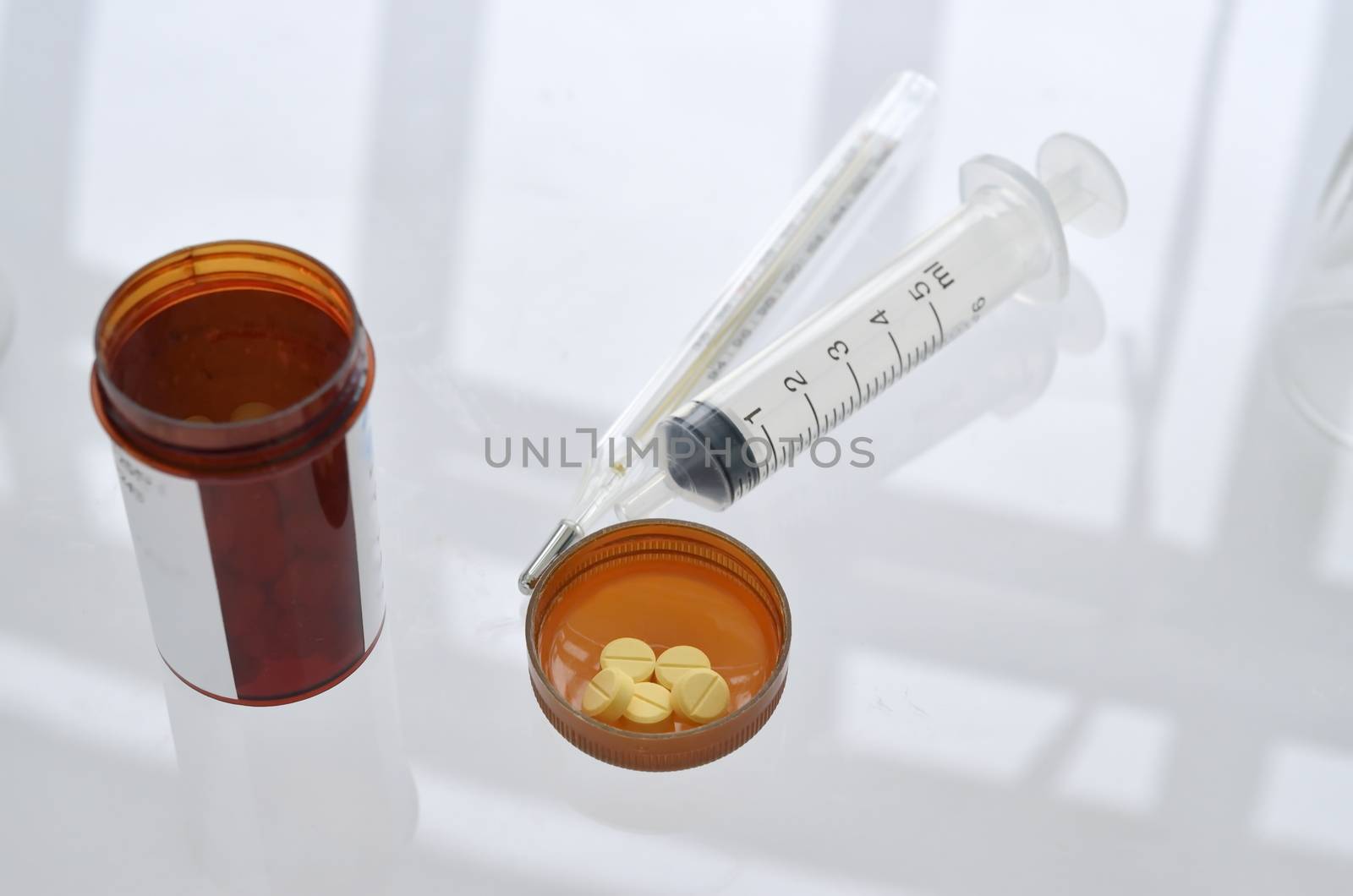 pills with pill bottle and syringe