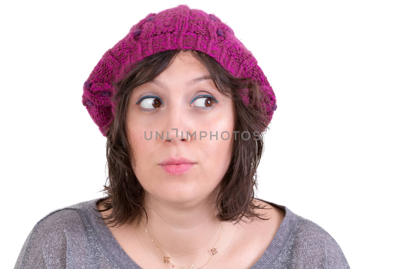 Young woman with a conscience being pricked with guilt looking furtively off to the side in trepidation, isolated on white