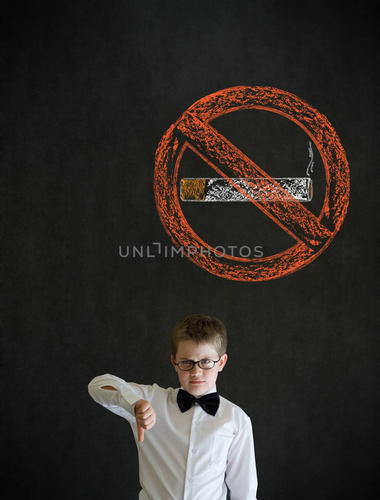 Thumbs down boy dressed up as business man with no smoking chalk sign on blackboard background