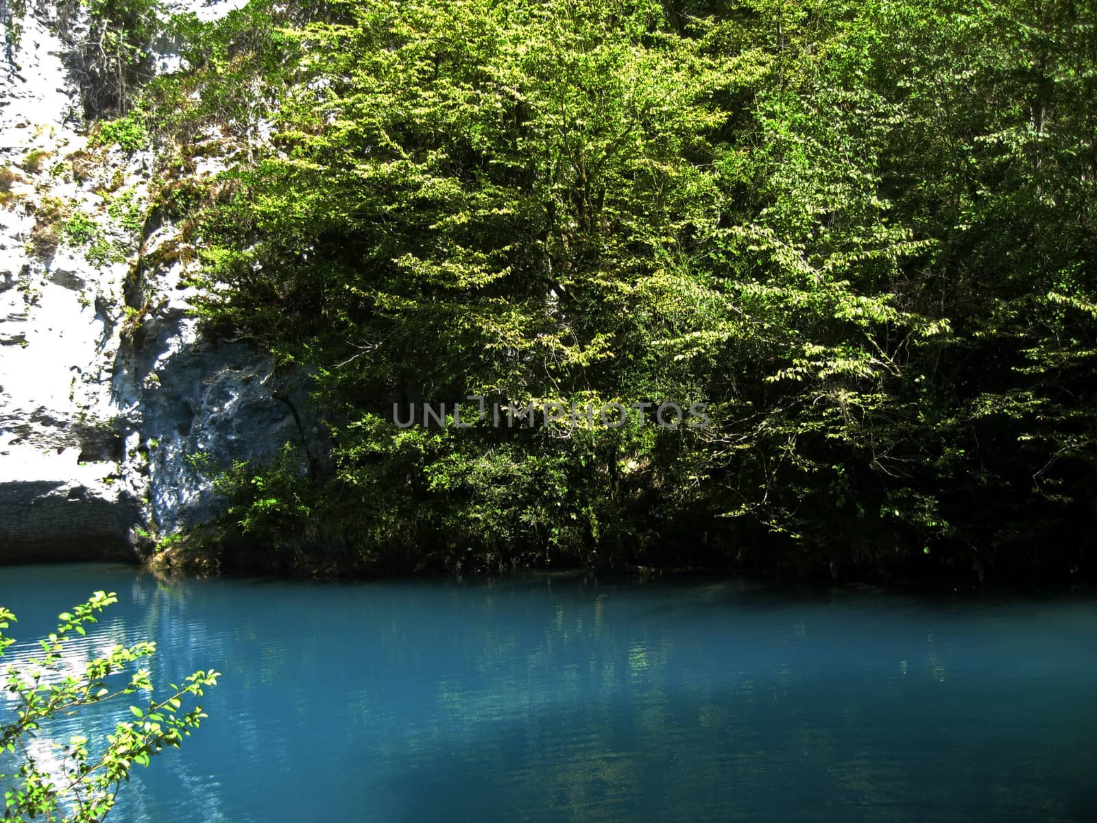 Little blue lake in the middle of the caucasus mountains