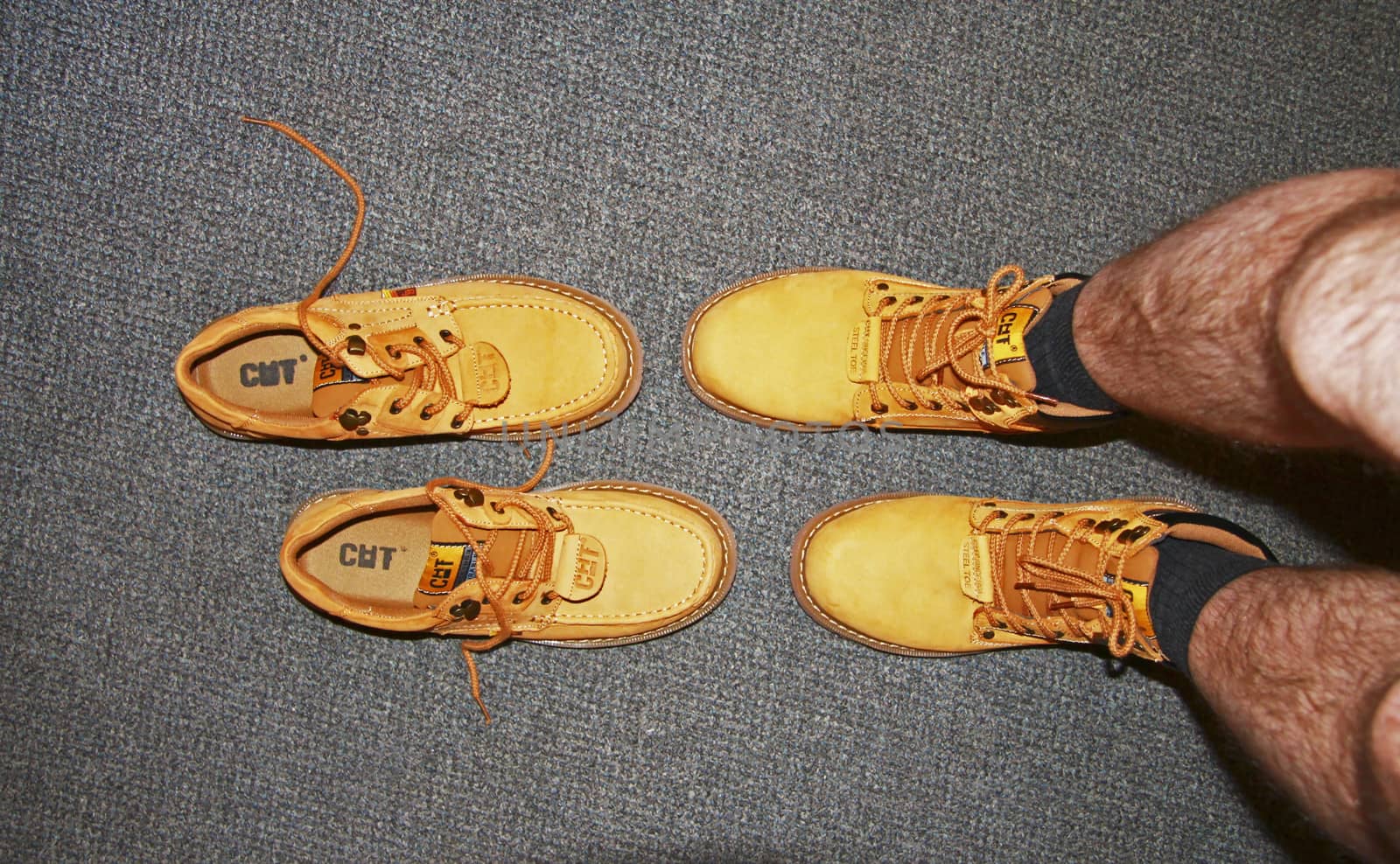 Yellow suede boots on the mans foot