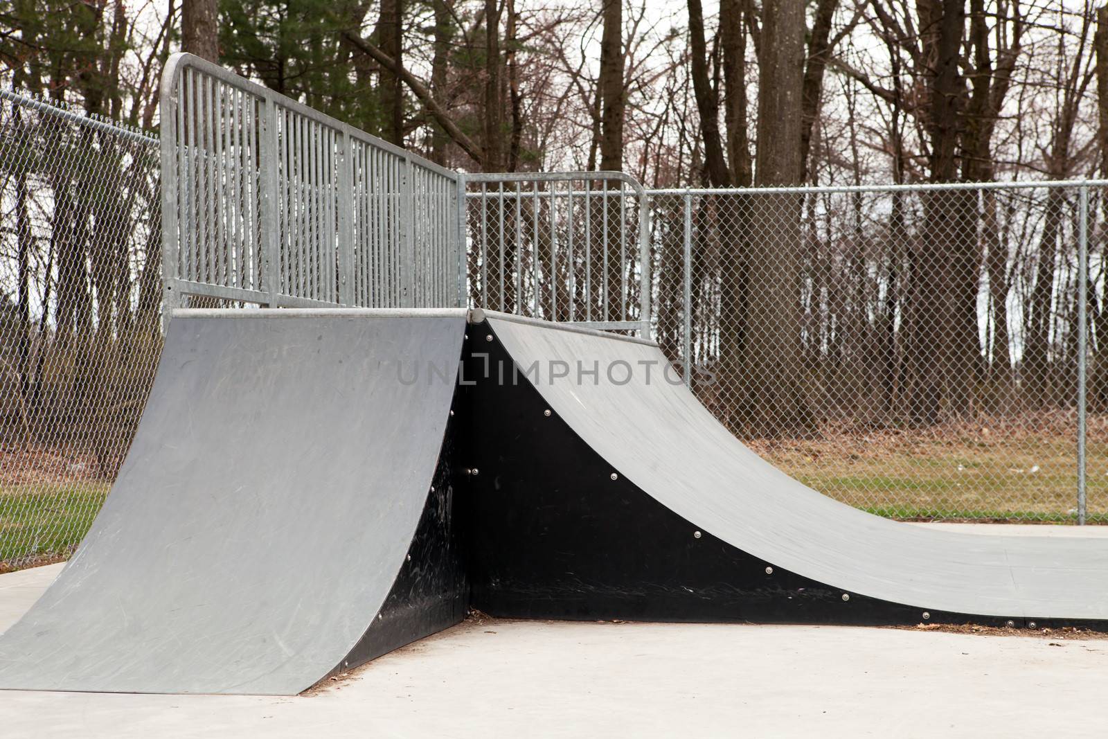 An empty set of ramps at an outdoor skate park.