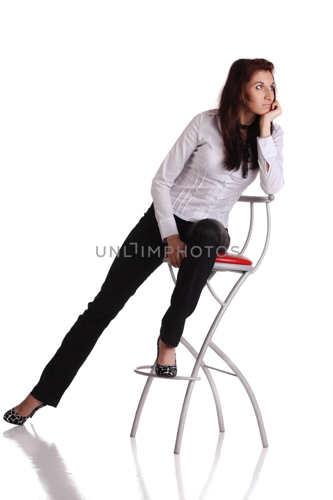 Girl sitting on the bar chair at white background