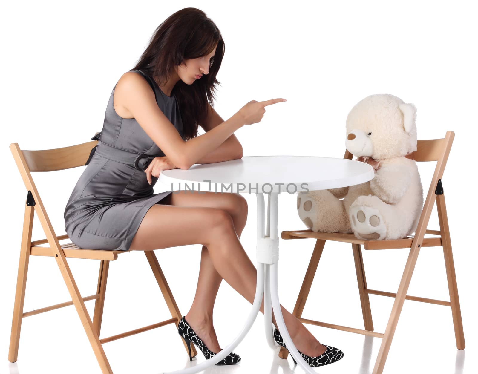 Young women running teddy bear down at white background