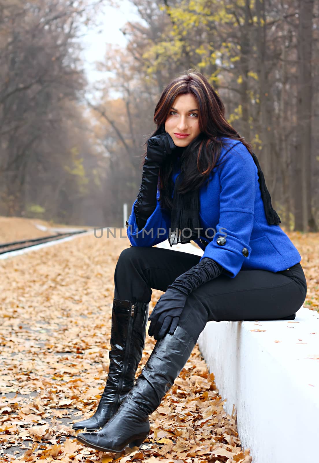 Young women sitting in the autumn park