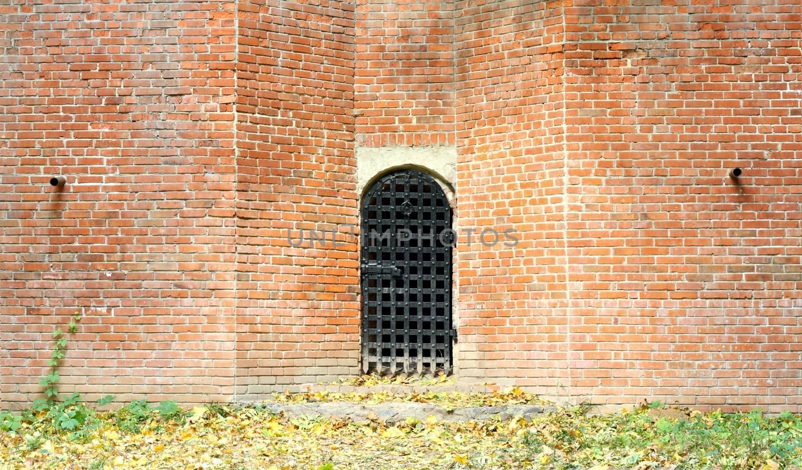 Closed iron door at the big brck wall