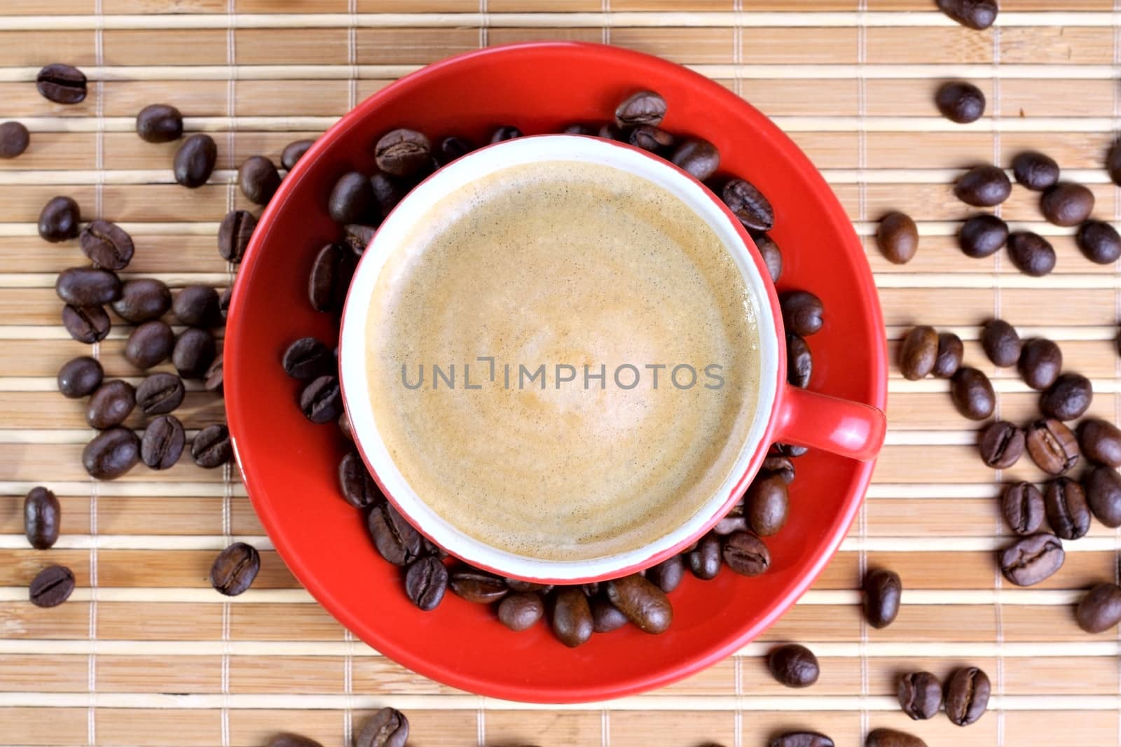 Cup of coffee with roasted beans at wooden background