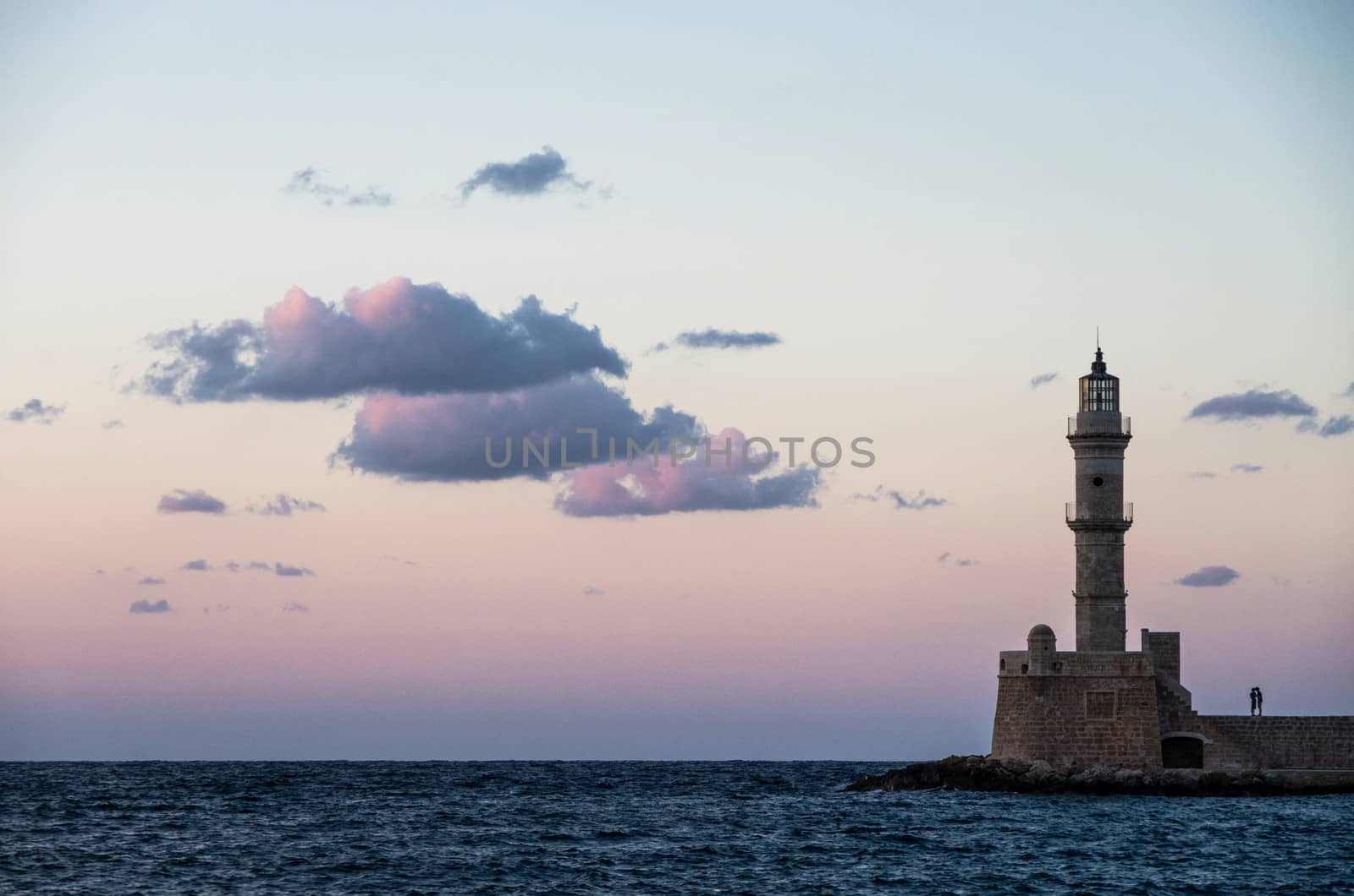 Two lovers kissing under the Chania's lighthouse