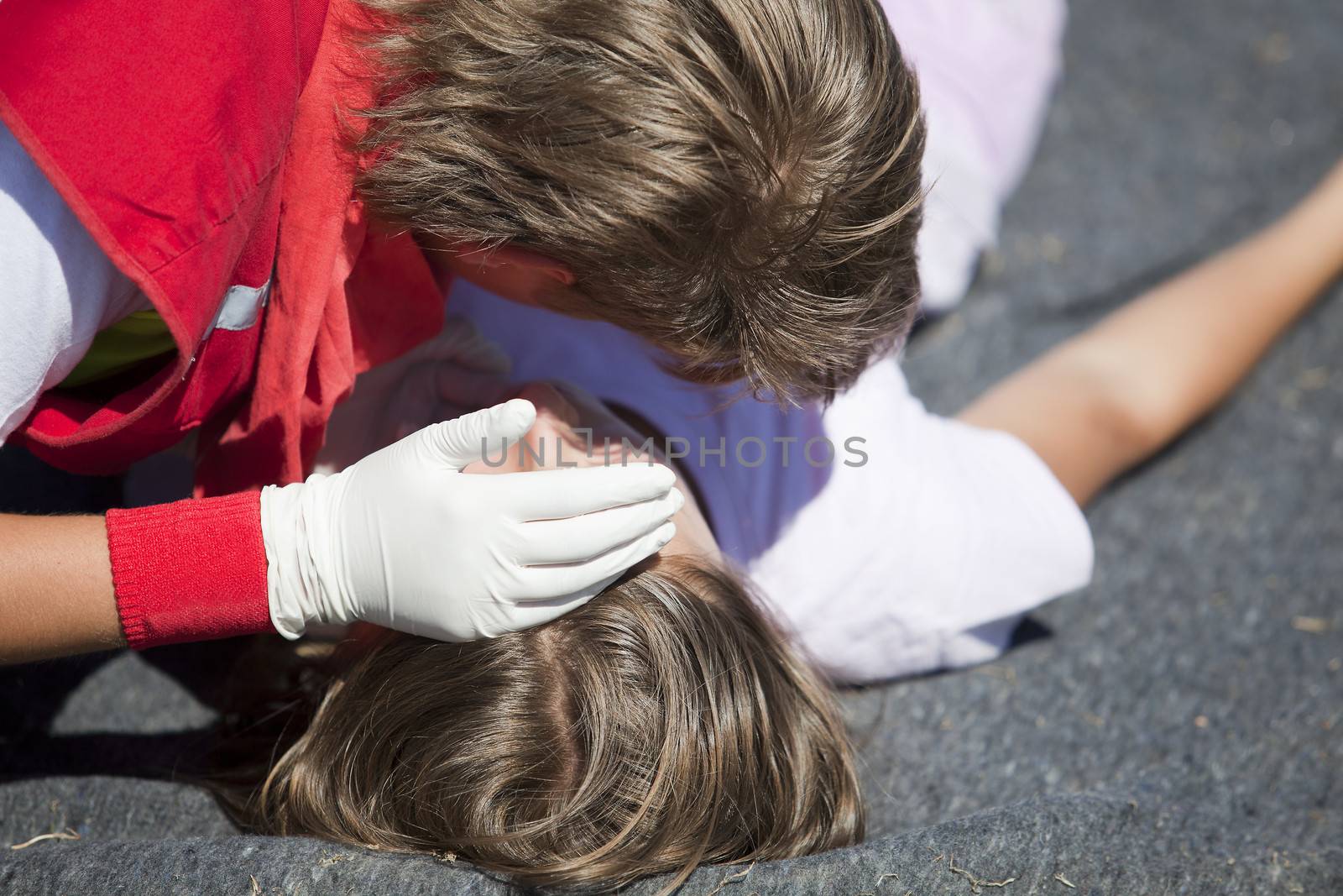 Paramedic demonstrates CPR on dummy