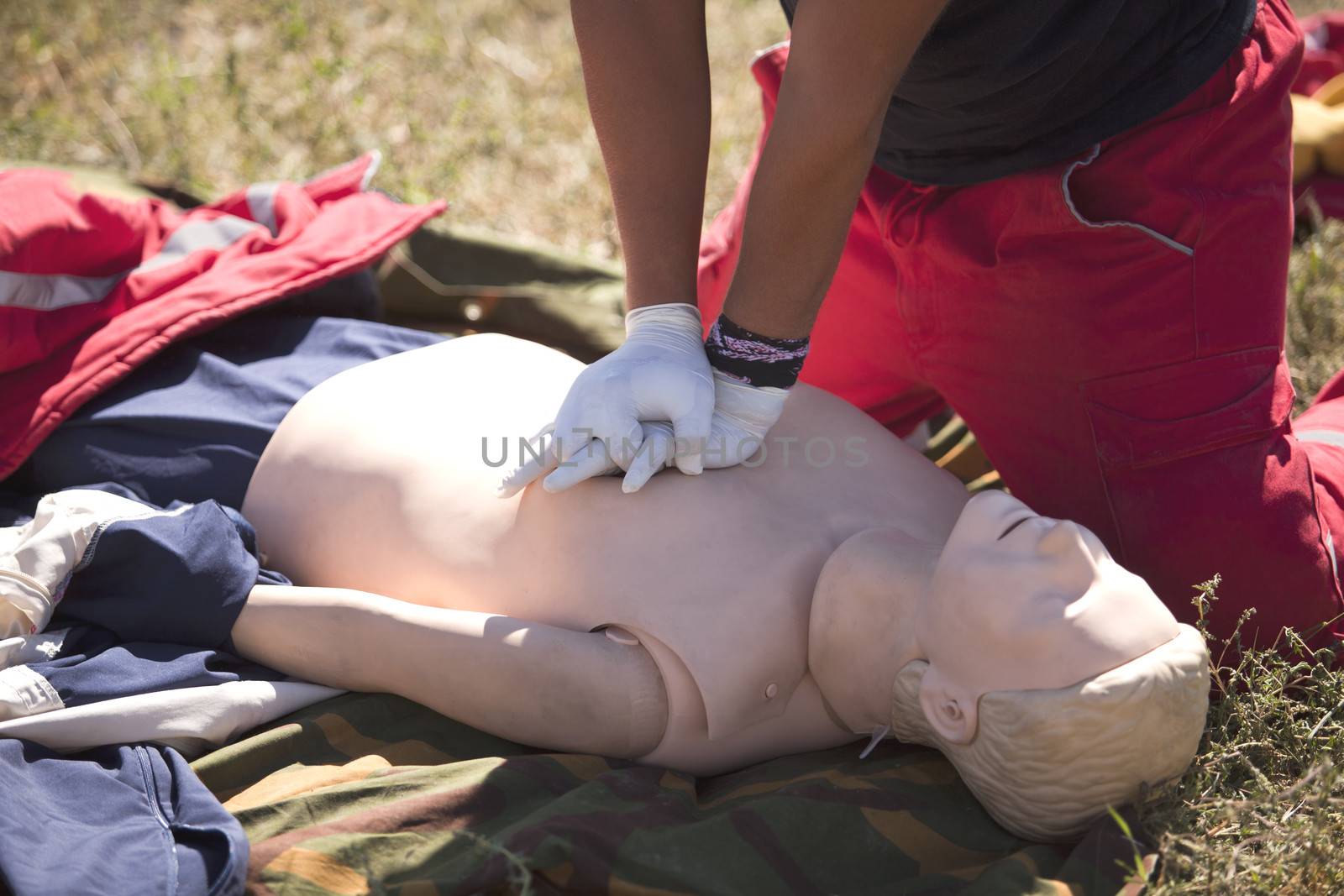 Paramedic demonstrates CPR on dummy