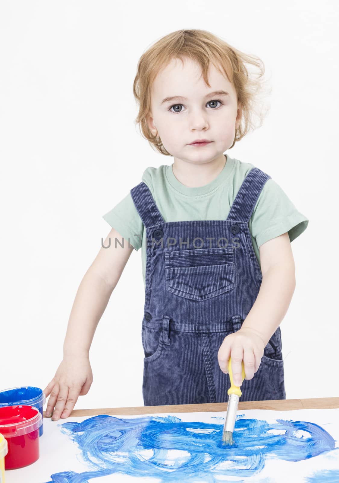 cute girl painting on small desk by gewoldi