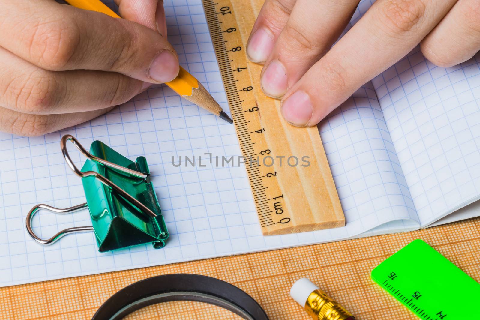 draftsman draws on a ruler on the graph paper