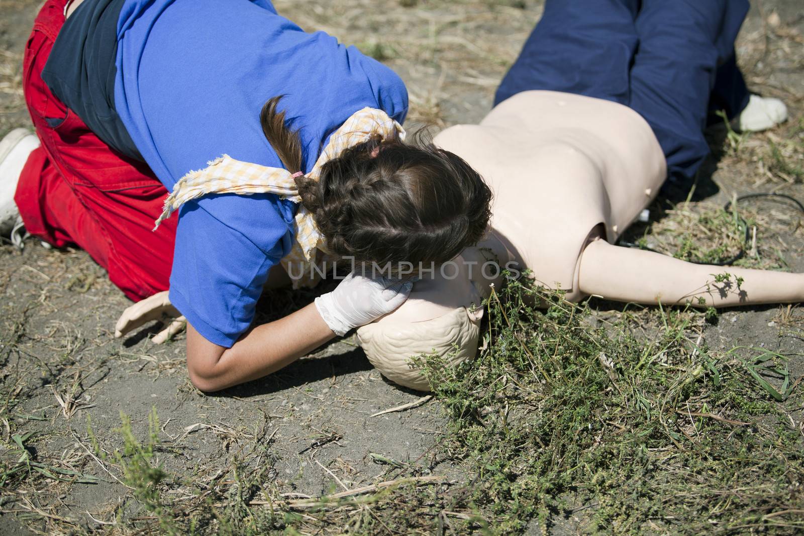 CPR practitioner examining airways on dummy