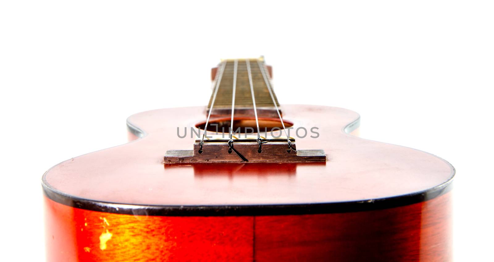 Old ukulele  on white background