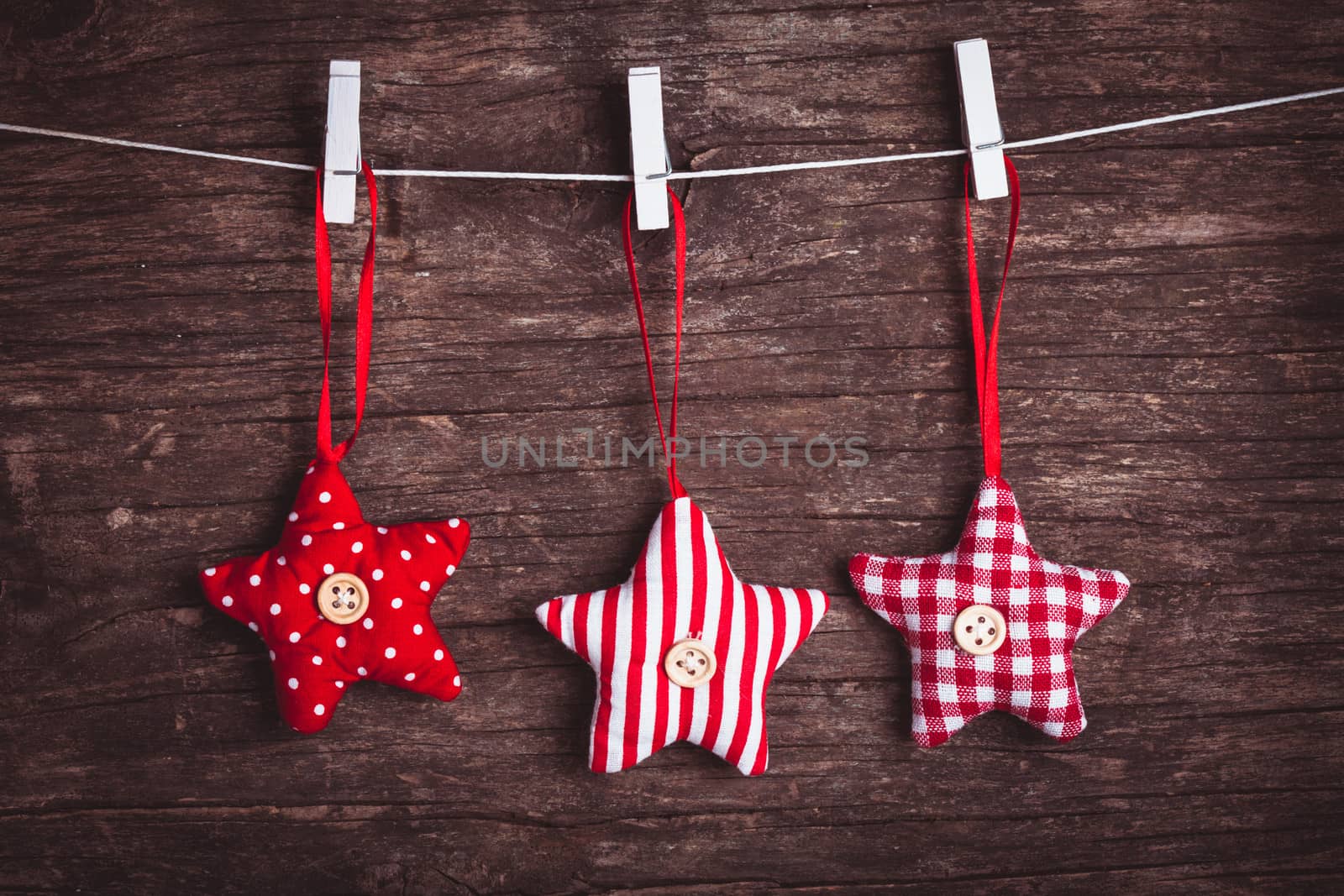 White and red sewed christmas stars attached to the rope