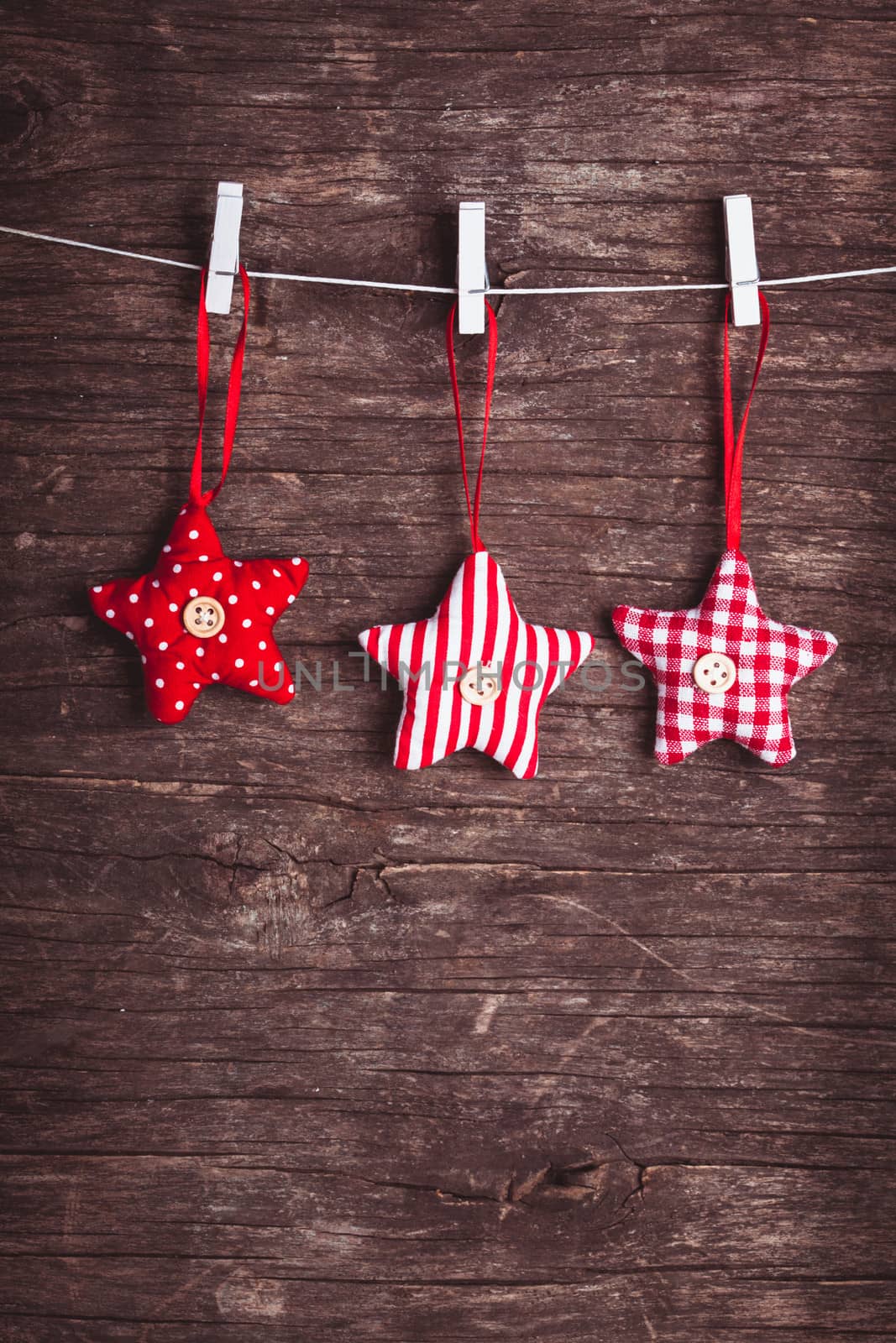 White and red sewed christmas stars attached to the rope