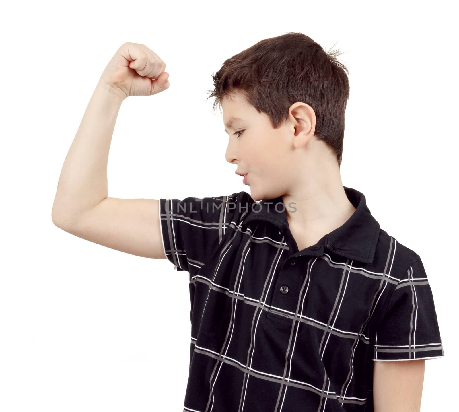 Portrait of a young boy with hand raised up and showing its own muscles against white background