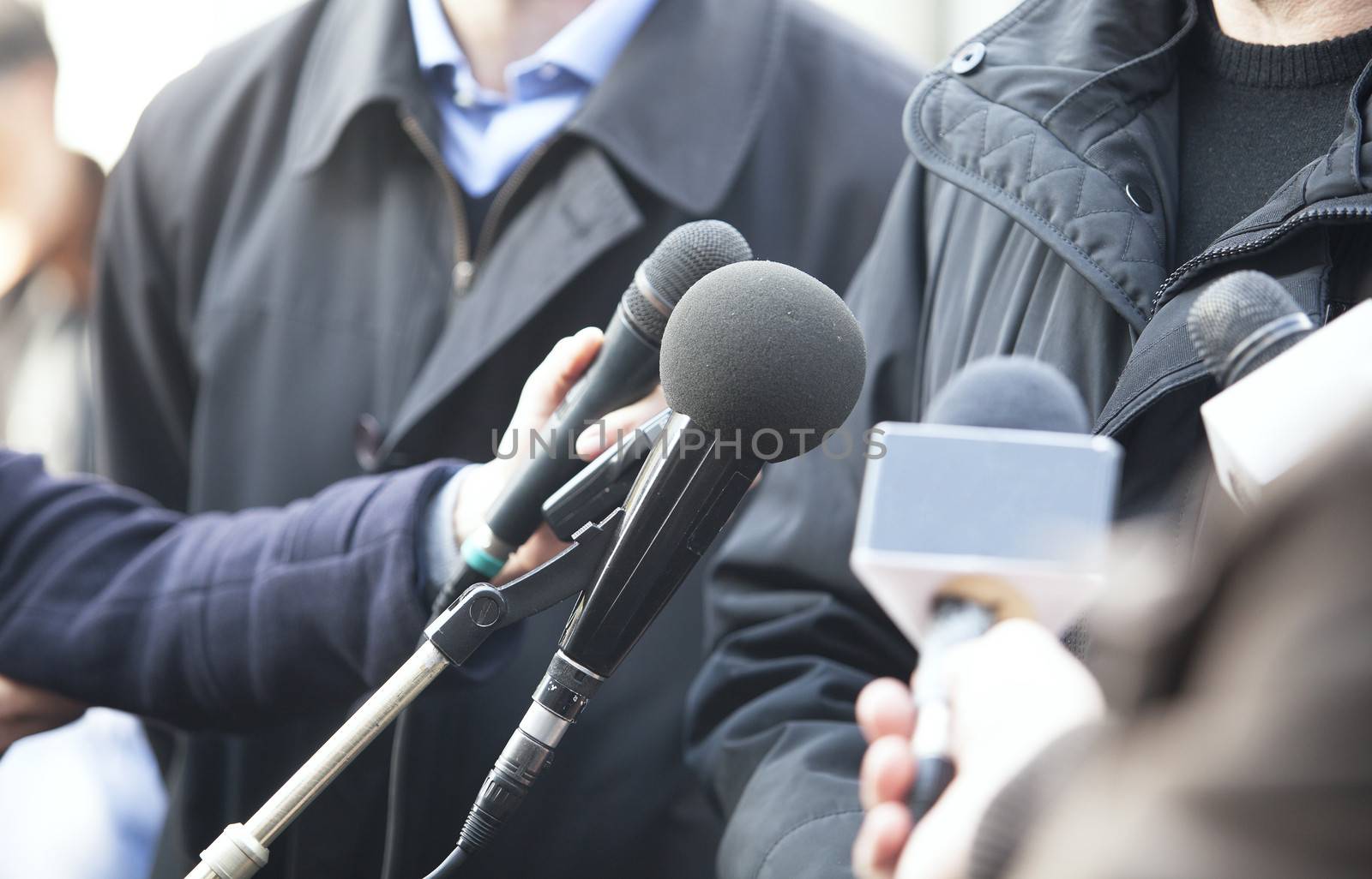 A journalist is making a interview with a microphone