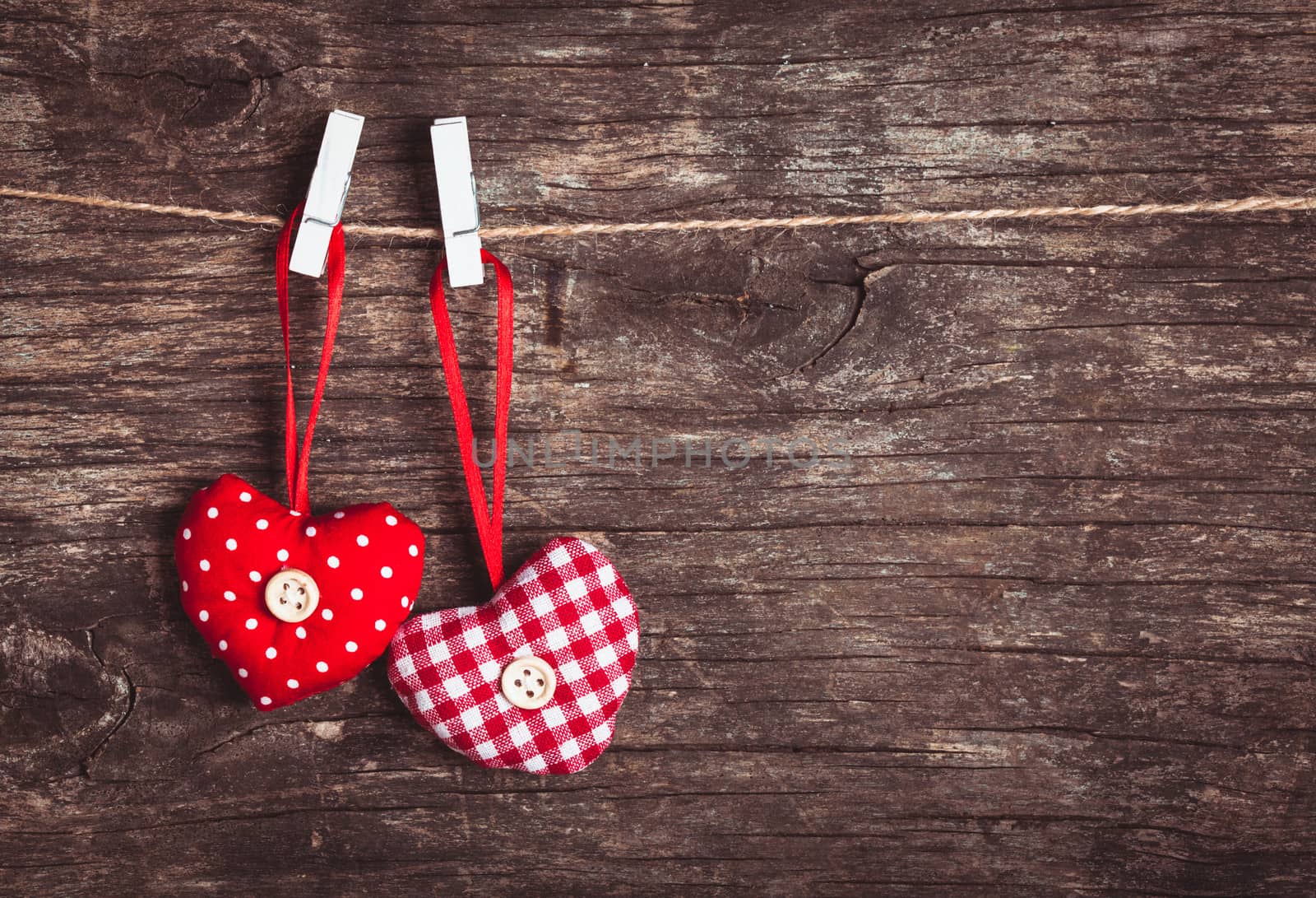 Two hearts .attached to the rope. Valentine greetings