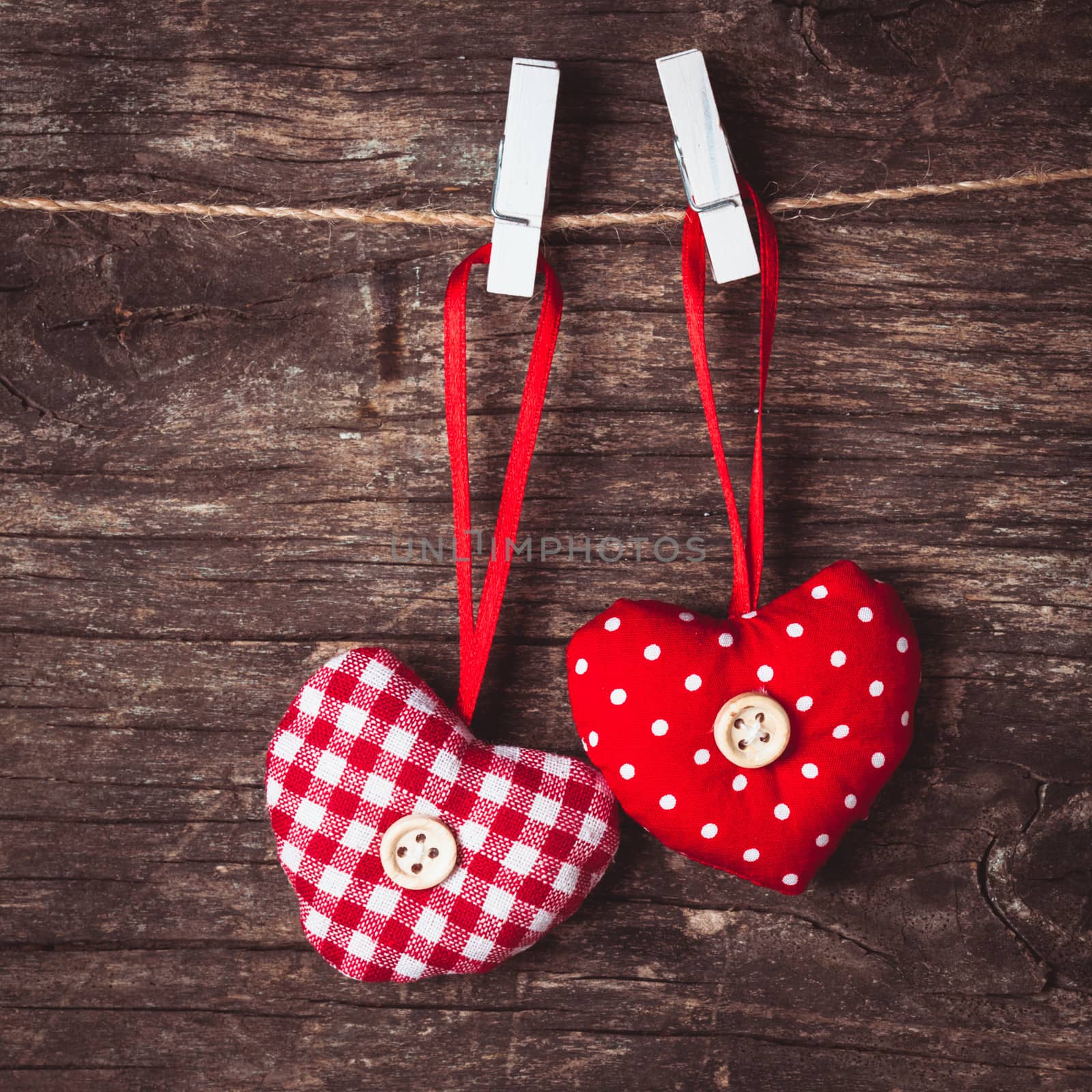 Two hearts .attached to the rope. Valentine greetings