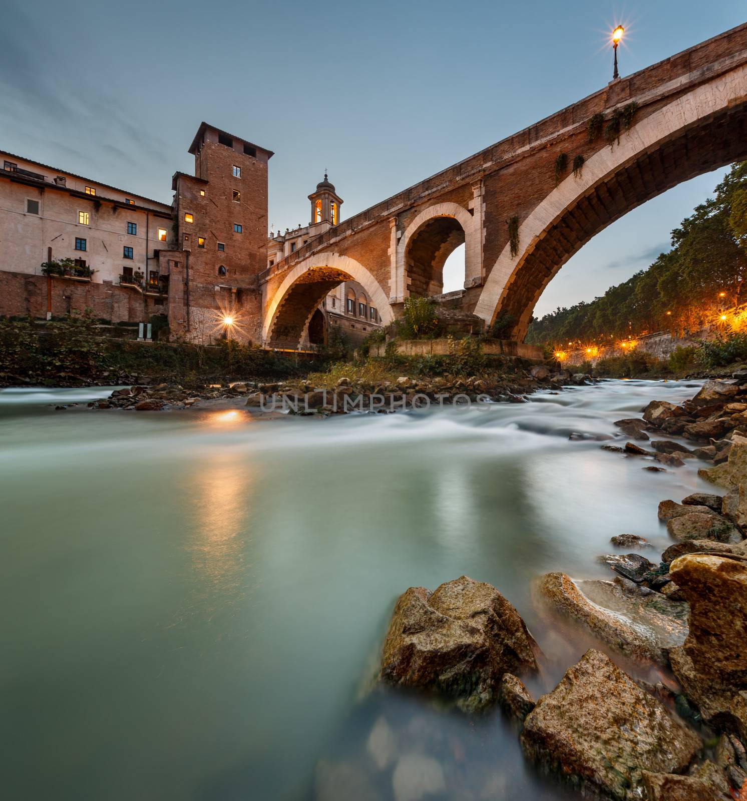 Fabricius Bridge and Tiber Island at Twilight, Rome, Italy. 
This is the oldest Roman bridge in Rome, still existing in its original state from 62 BC, built by Lucius Fabricius.
