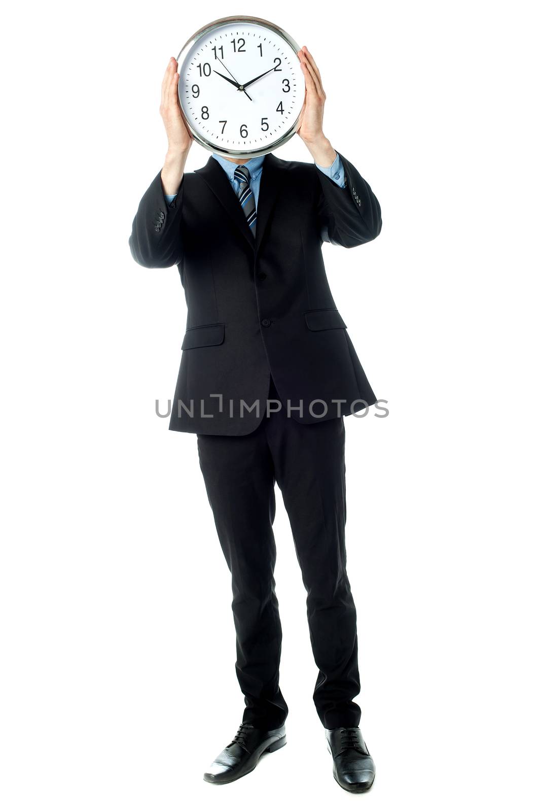 Businessman covering his face with wall clock