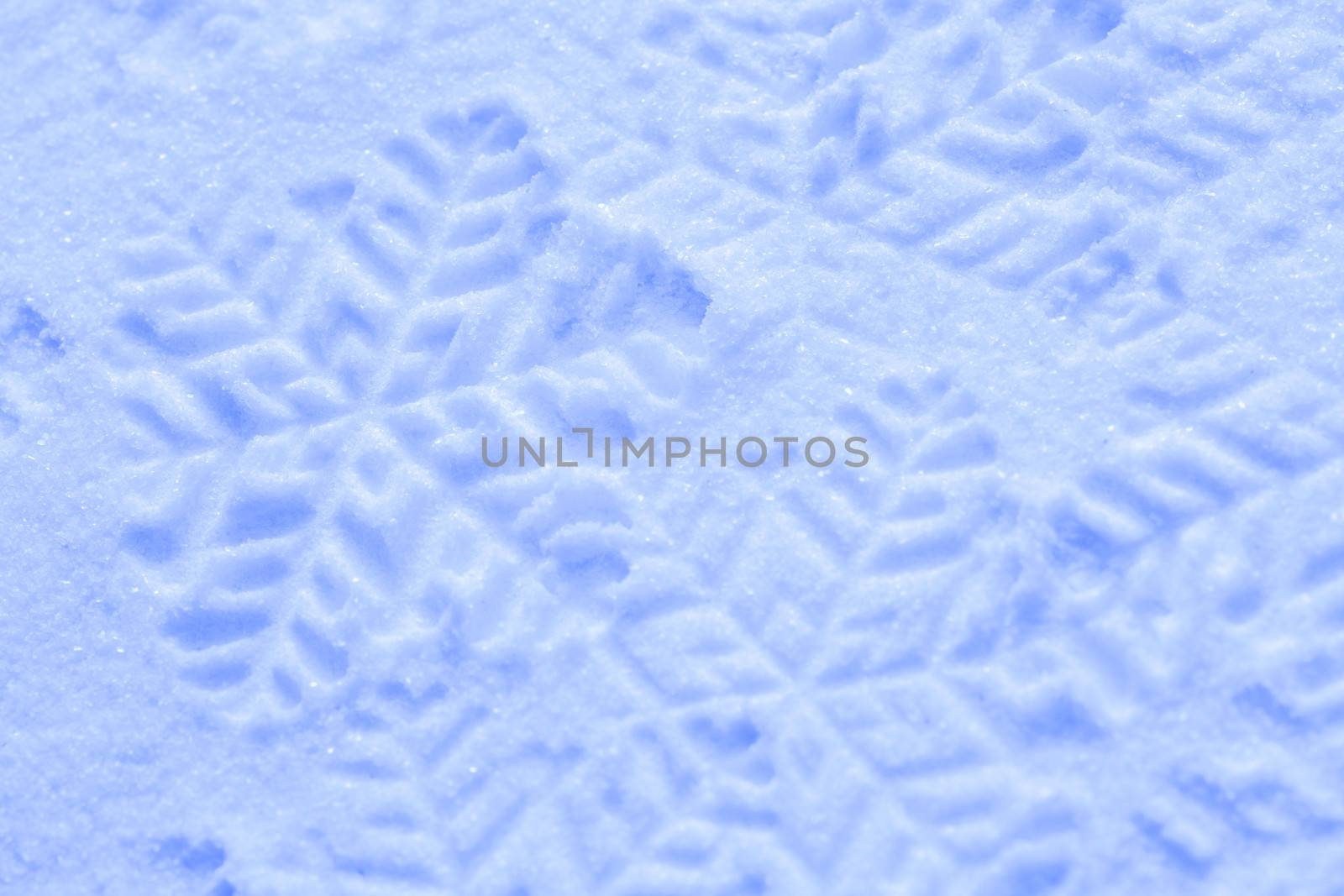 Snowflake on the snow. White xmas holiday background.