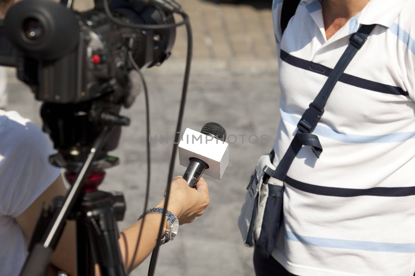 A journalist is making a interview with a microphone