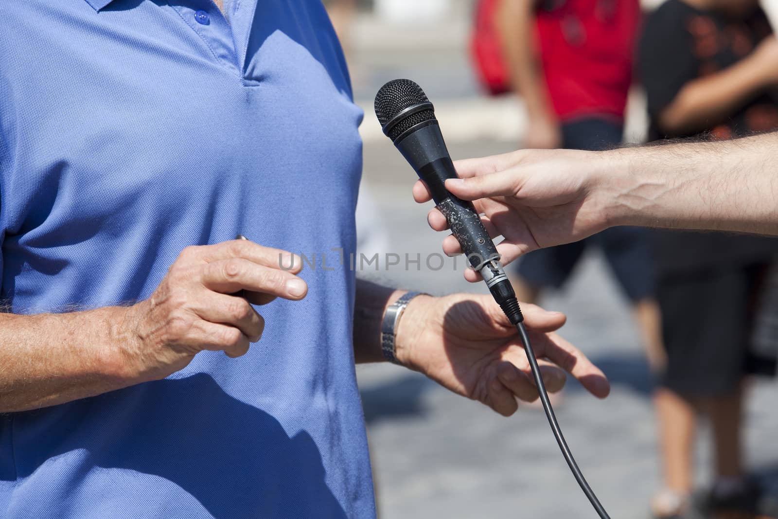 A journalist is making a interview with a microphone