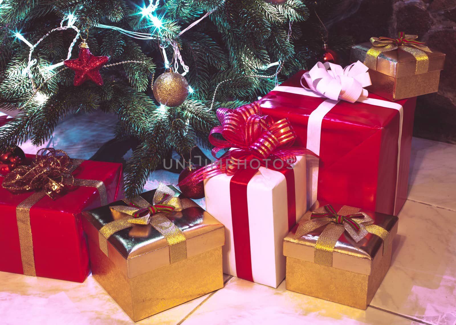 Presents boxes under the Christmas tree. Gold, red and white colours