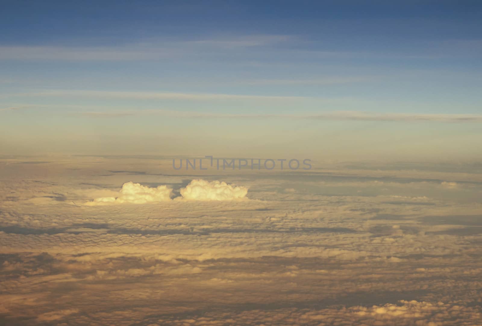 Blue and silver clouds background, view from airplane