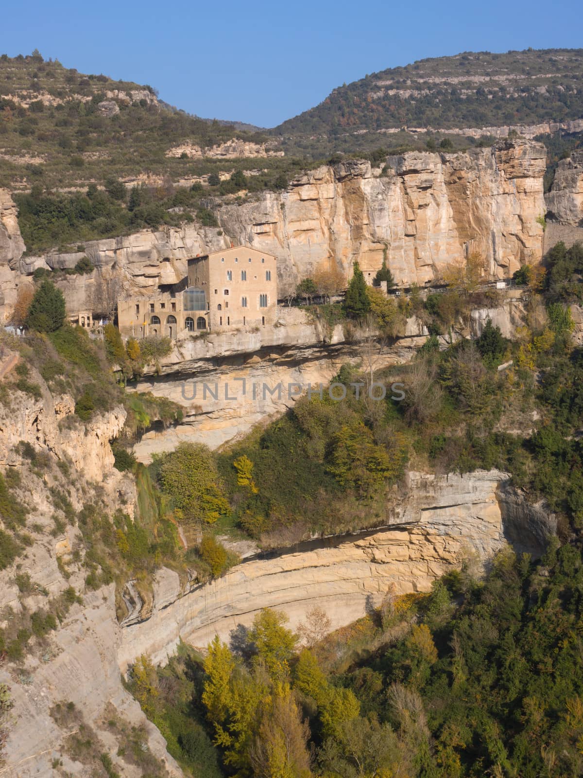 The monastic complex of Sant Miquel del Fai in Central Catalonia, Spain, which stays hanging in the middle of a cliff emulating the bird’s nests that also inhabit those water modeled rocks.