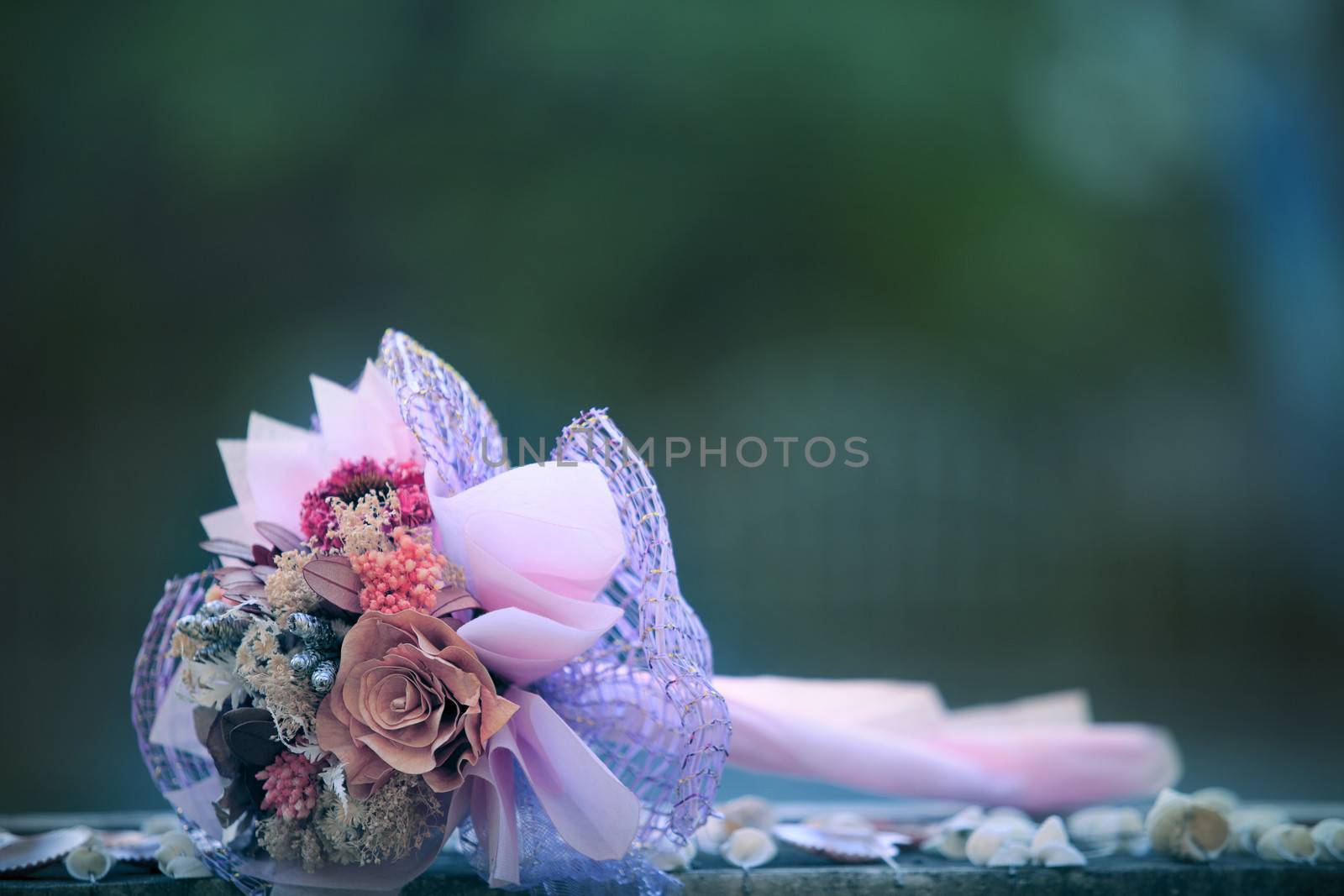 dry flowers bouquet lying on wood table with blurry background