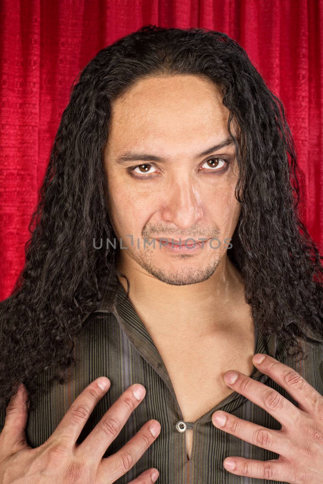 Close up of sensual Hispanic man with long hair