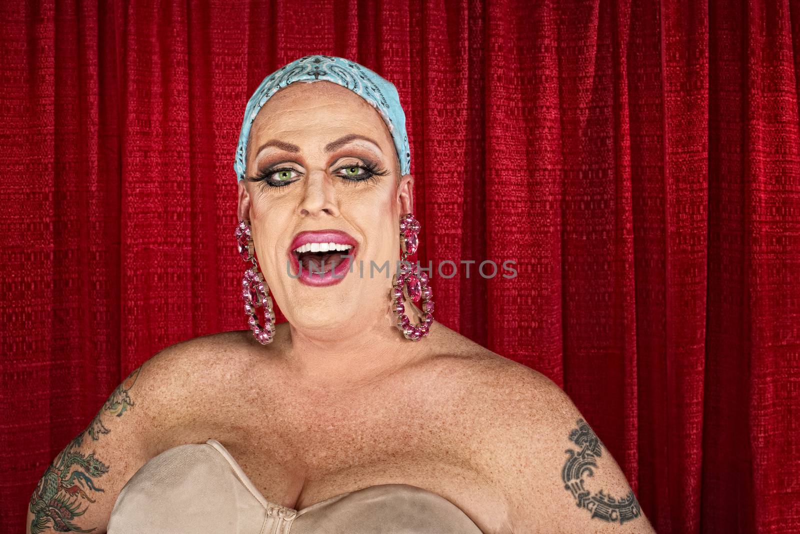Laughing Caucasian drag queen with head covering