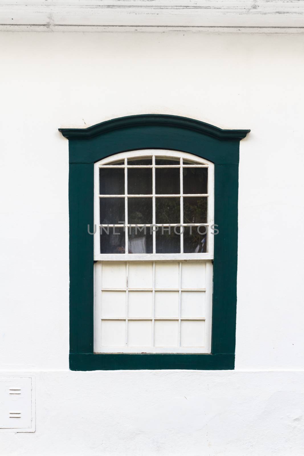 Decorative, colonial, vintage, window on a white wall in Paraty (or Parati), Brazil.
