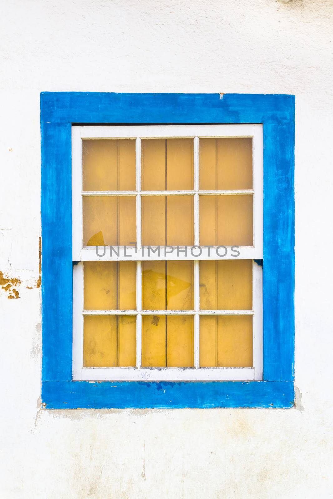 Decorative, colonial, blue, vintage, window on a white wall in Paraty (or Parati), Brazil.
