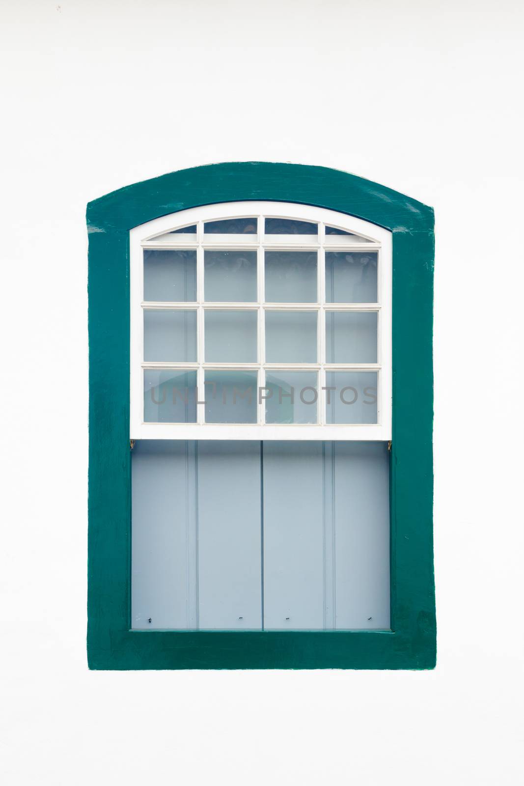 Decorative, colonial, green, vintage, window on a white wall in Paraty (or Parati), Brazil.