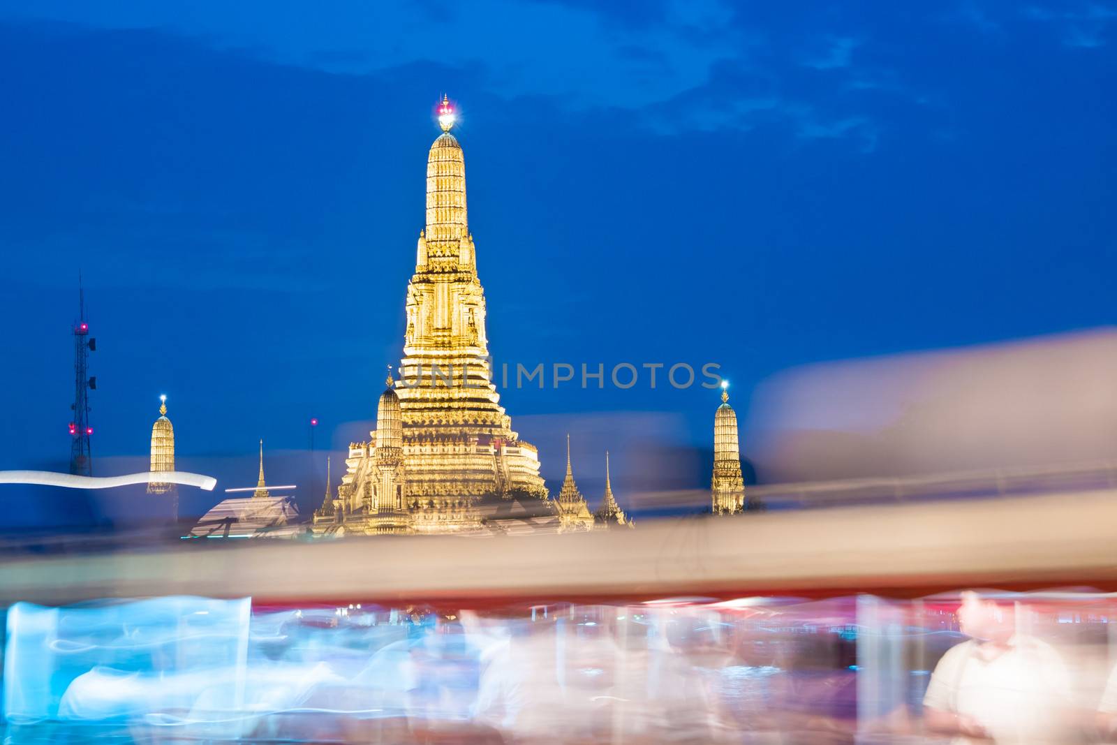 Bangkok, Thailand - Wat arun in dusk. People going from work in a publik boat on the Chao Phraya river.