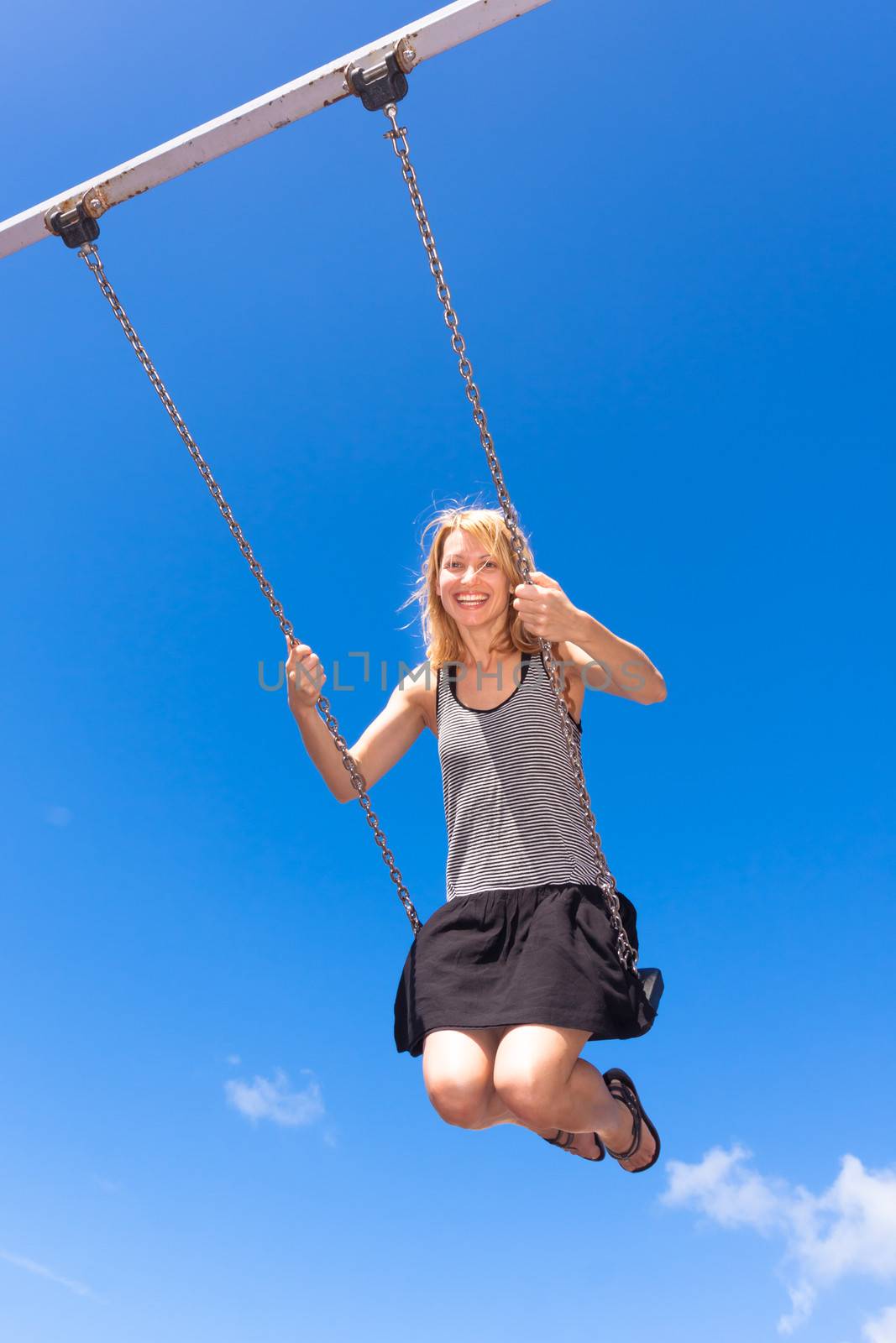 Woman swinnging on a swing. by kasto