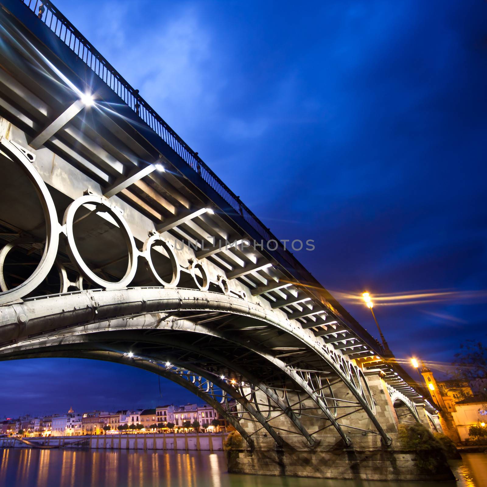 Panorama of Seville riverside at down under the Triana Bridge, the oldest bridge of Seville.