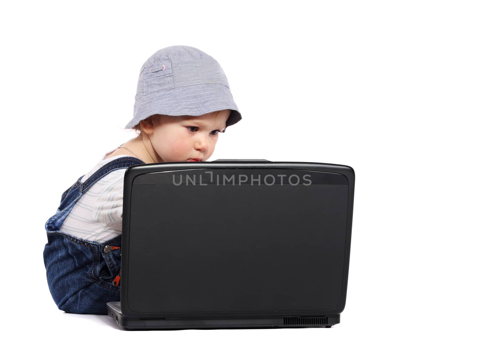 Little boy sitting with a laptop isolated on the white